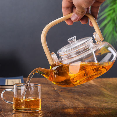 Pote floreciente transparente del té con el filtro, taza de té soplada mano fijada con la caldera proveedor
