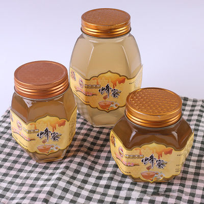 Contenedor de almacenamiento reciclable de la comida de la miel de la tapa del metal del tarro de la forma de cristal del hexágono proveedor