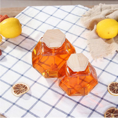 Vidrio a prueba de calor Honey Jar del hexágono del goteador de madera proveedor